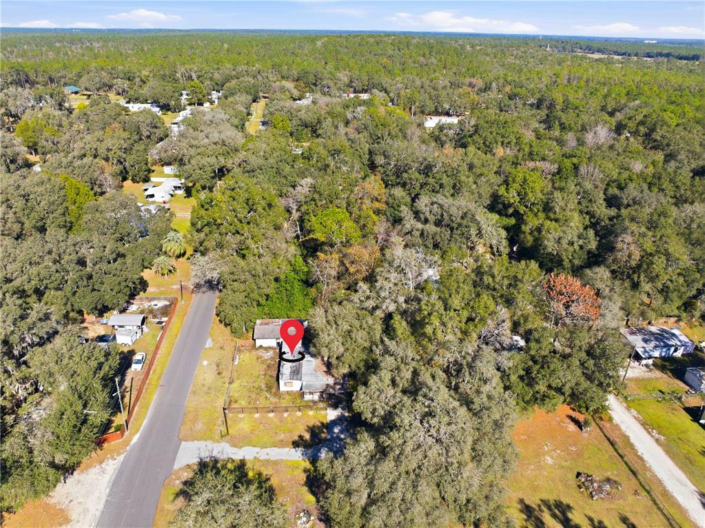 An aerial view shows a small house with a red location pin among trees — 4265 S ILLIANA TERRACE, INVERNESS, FL