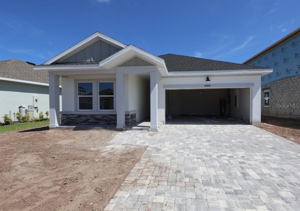 This is a digital rendering of a single-story suburban house with a two-car garage — 10665 CRESCENT CREEK CROSSING, PARRISH, FL