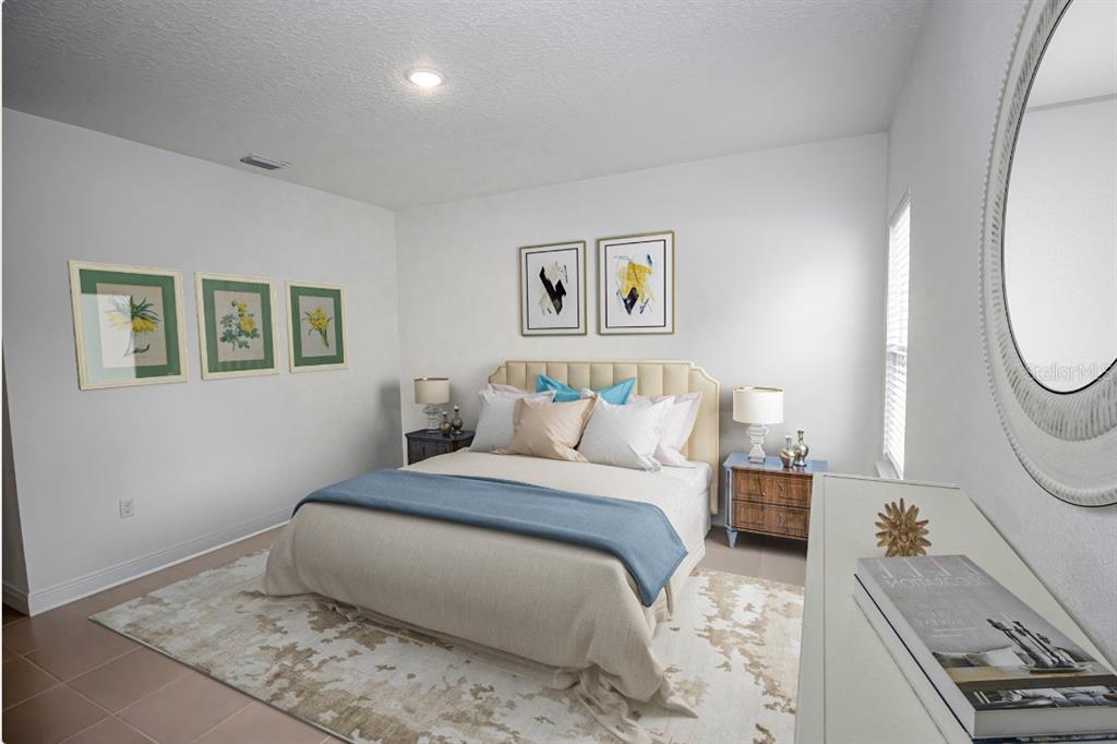 A bedroom features a bed with a blue throw, two nightstands, and wall art — 14587 SW 25TH TER, OCALA, FL 34473, OCALA, FL