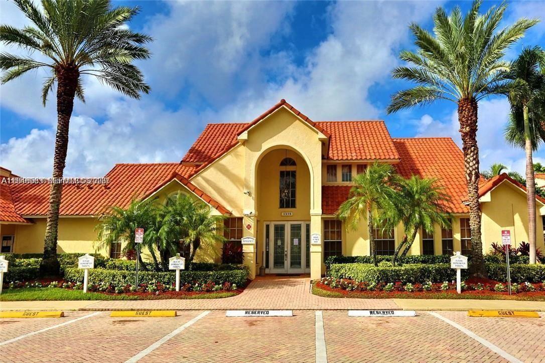 A yellow building with a red tile roof stands behind a brick parking lot — 1239 SW 46th Ave # 903, Pompano Beach FL 33069, POMPANO BEACH, FL