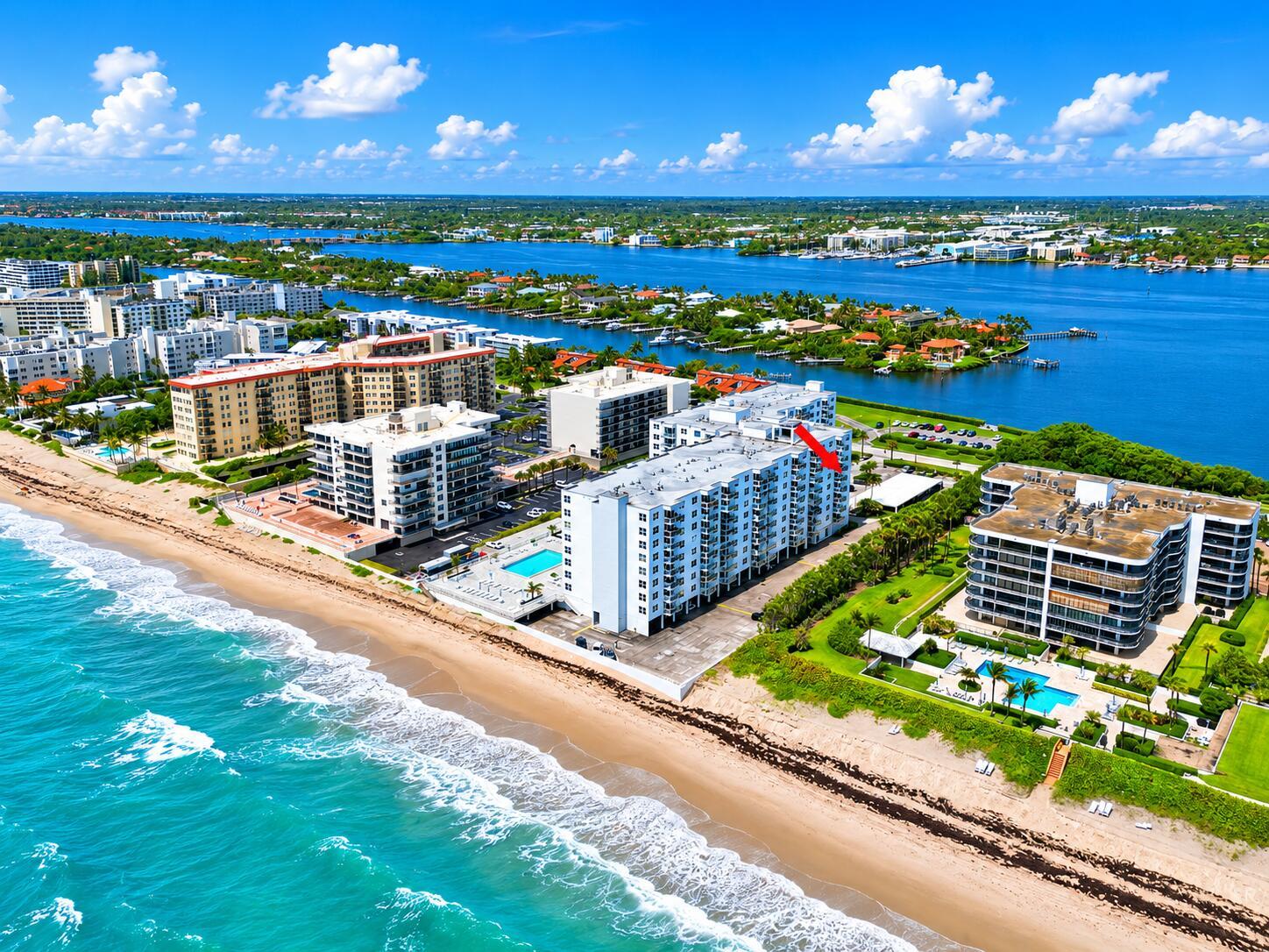 An aerial view of beachfront condominium buildings with swimming pools along a sandy coastline — 3450 S Ocean Boulevard # 6010, Palm Beach FL 33480, PALM BEACH, FL