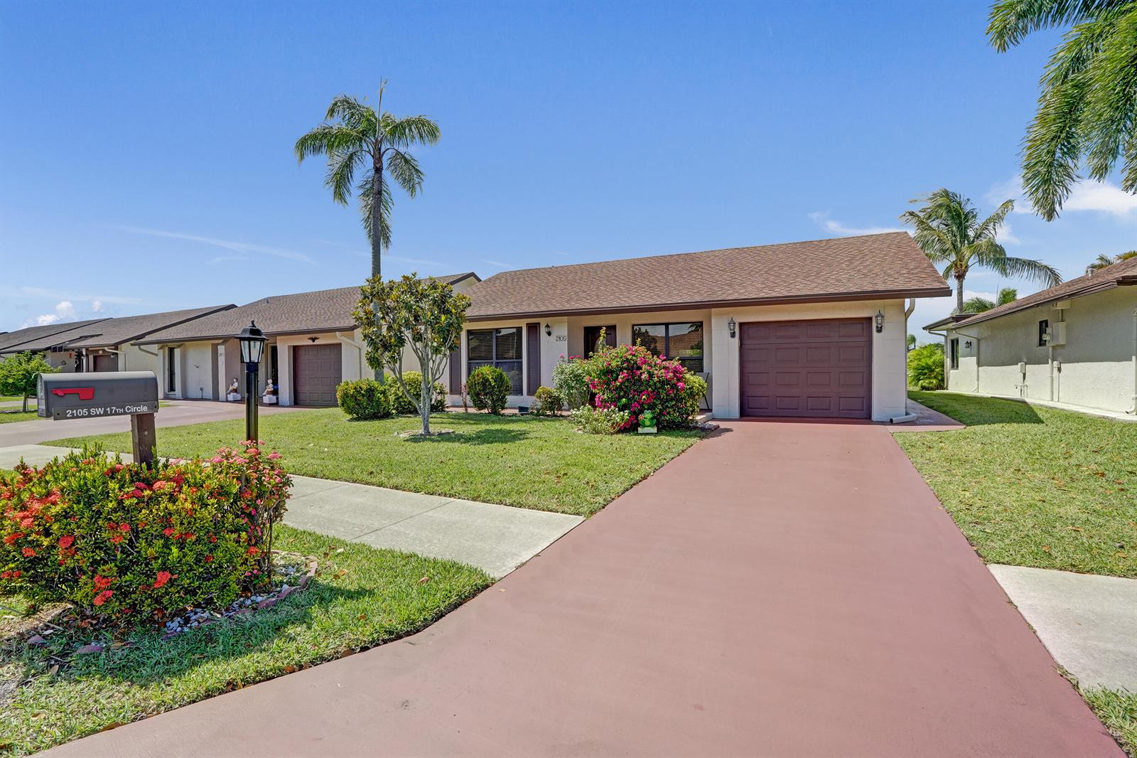 A single-story house with a brown garage door, a red driveway, and palm trees — 2105 SW 17th Circle, Deerfield Beach FL 33442, DEERFIELD BEACH, FL