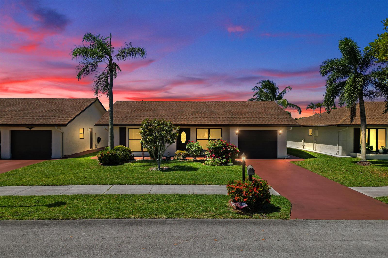 A single-story house with a brown roof, palm trees, and a red driveway at sunset — 2105 SW 17th Circle, Deerfield Beach FL 33442, DEERFIELD BEACH, FL