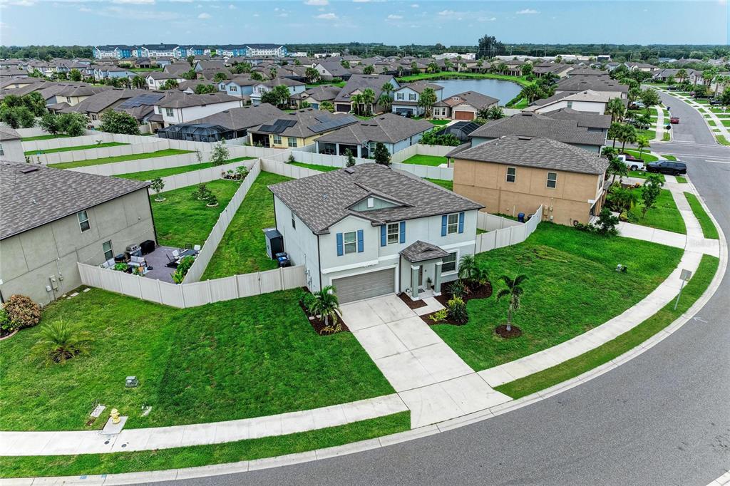 An aerial view of a two-story suburban house with a driveway and fenced backyard — 5512 OLANO STREET, PALMETTO, FL