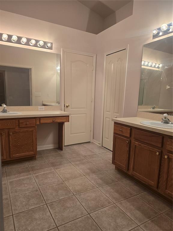 A view from a wood-floored living area through an arched opening into a tiled kitchen — 31125 HANNIGAN PLACE, WESLEY CHAPEL, FL