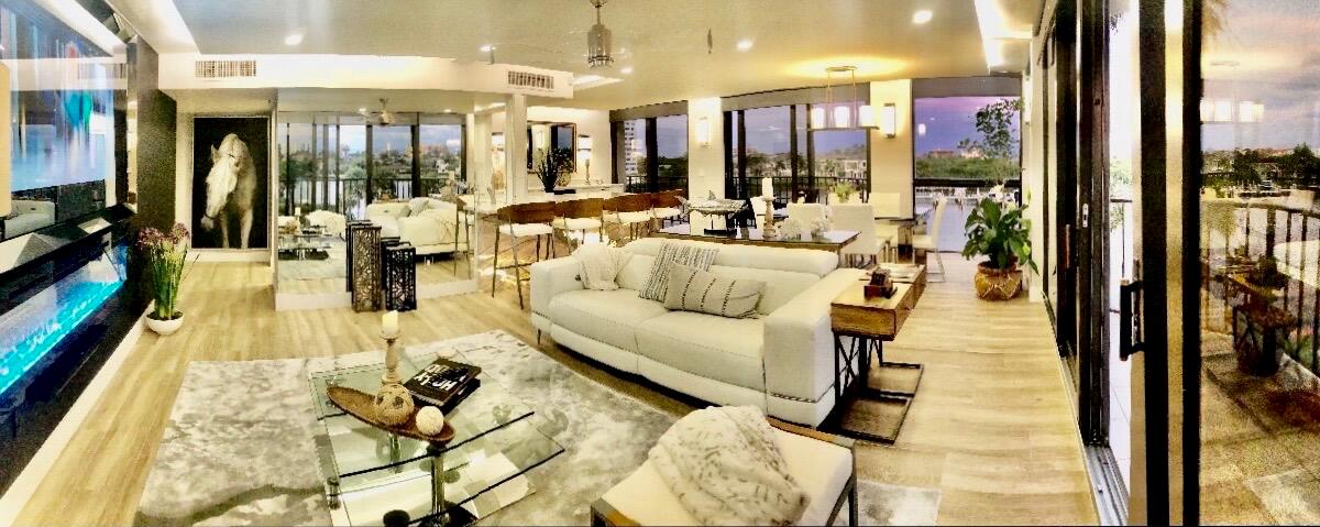 A modern open-concept living room features a white sofa, glass coffee table, and fireplace — 899 Jeffery Street # 4150, Boca Raton FL 33487, BOCA RATON, FL