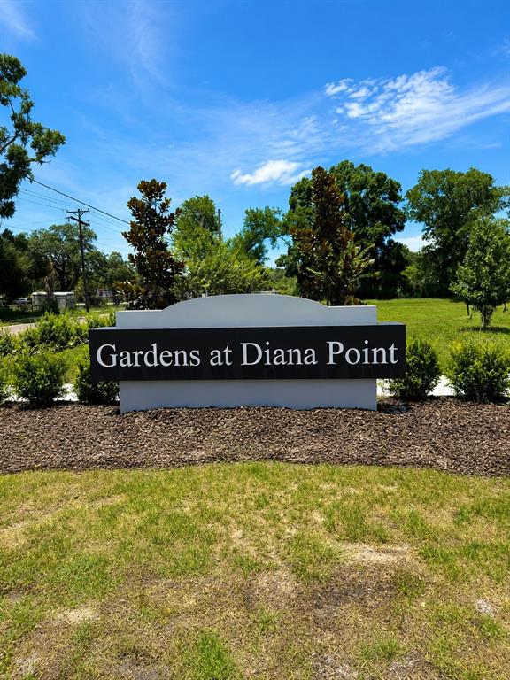 A sign for Gardens at Diana Point stands in a landscaped area under a blue sky — 4347 CAMBIO GARDENS COURT, TAMPA, FL