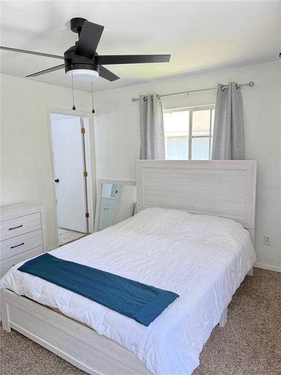 A bedroom features a white bed frame, a matching dresser, and a ceiling fan — 2235 FLUORSHIRE DRIVE, BRANDON, FL