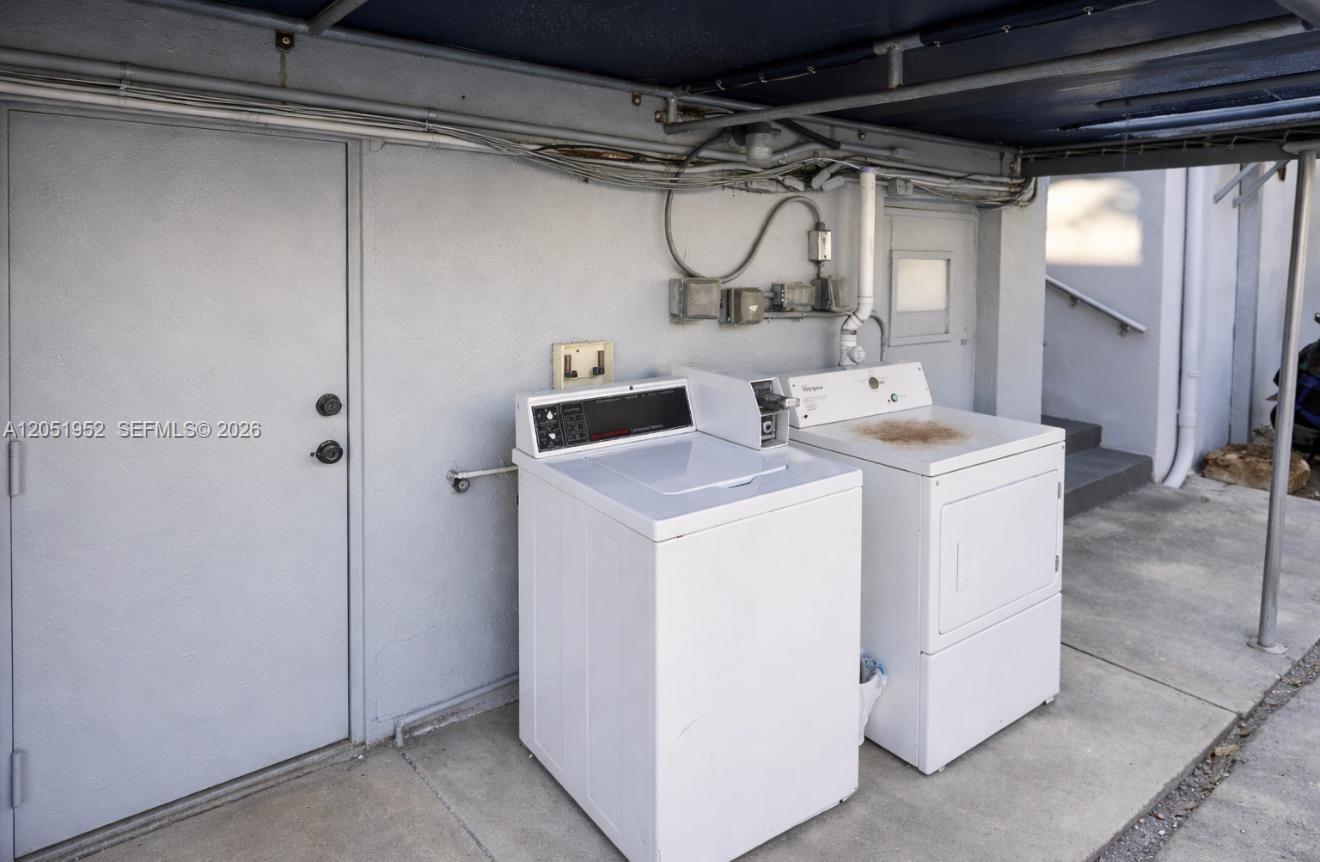 A washer and dryer are located on an outdoor concrete patio near a door — 5305 Biscayne Blvd # 203, Miami FL 33137, MIAMI, FL