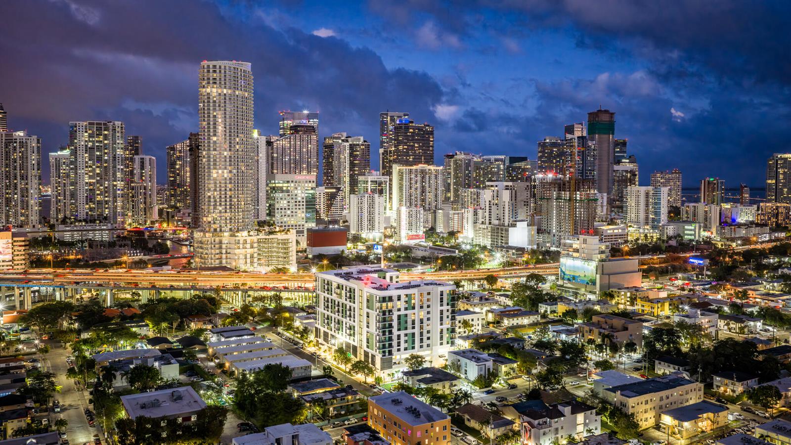An elevated night view of the Miami skyline featuring high-rise buildings and illuminated city streets — 450 SW 5th Street # 401, Miami FL 33130, MIAMI, FL