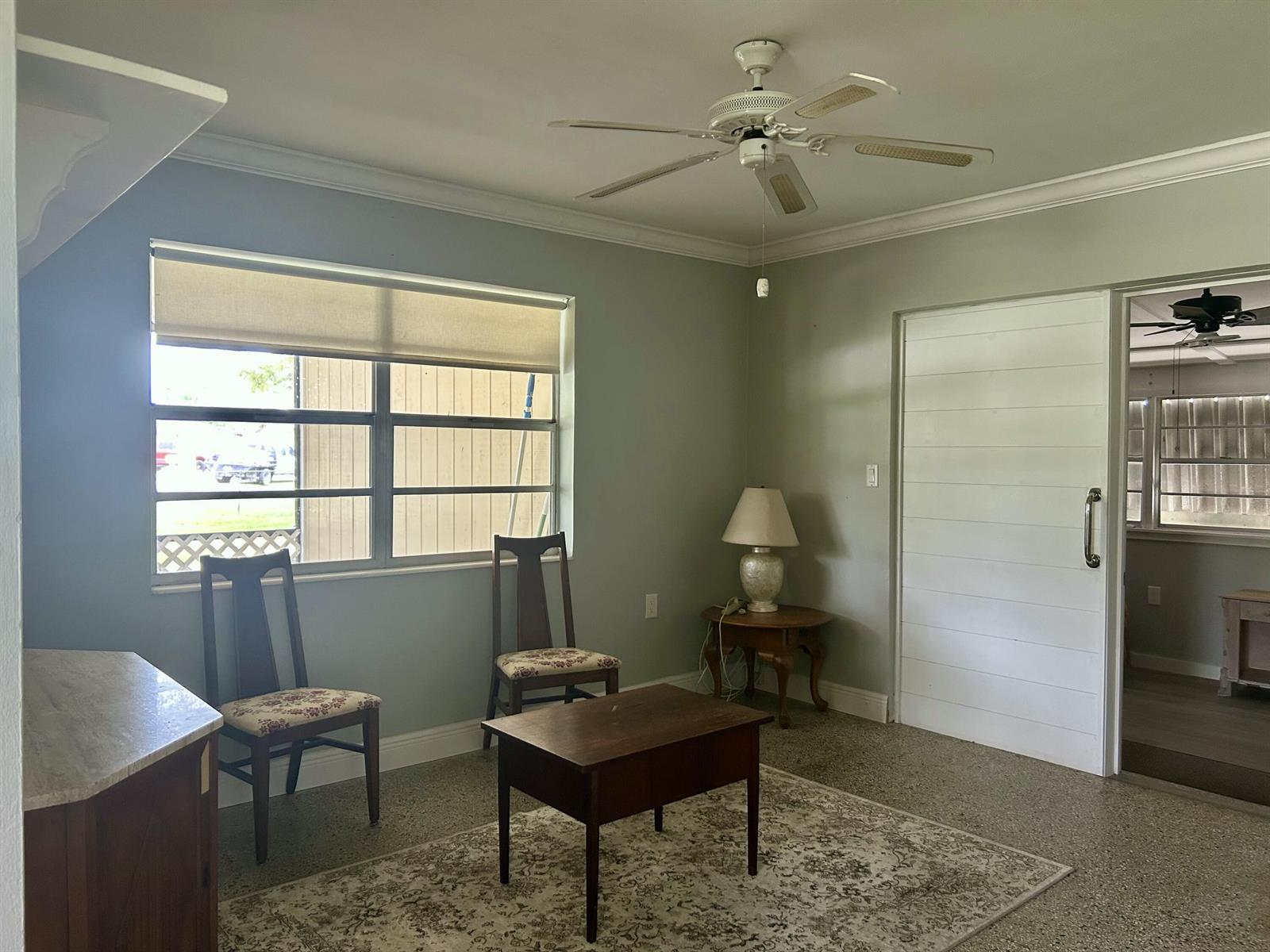 A room with light green walls, a ceiling fan, two chairs, a table, and flooring — 3632 NW 25th Avenue, Okeechobee FL 34972, OKEECHOBEE, FL