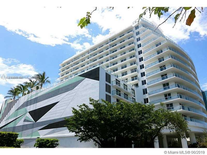 A low-angle exterior view of a modern white high-rise building with glass balconies — 4250 Biscayne Blvd # 1517, Miami FL 33137, MIAMI, FL