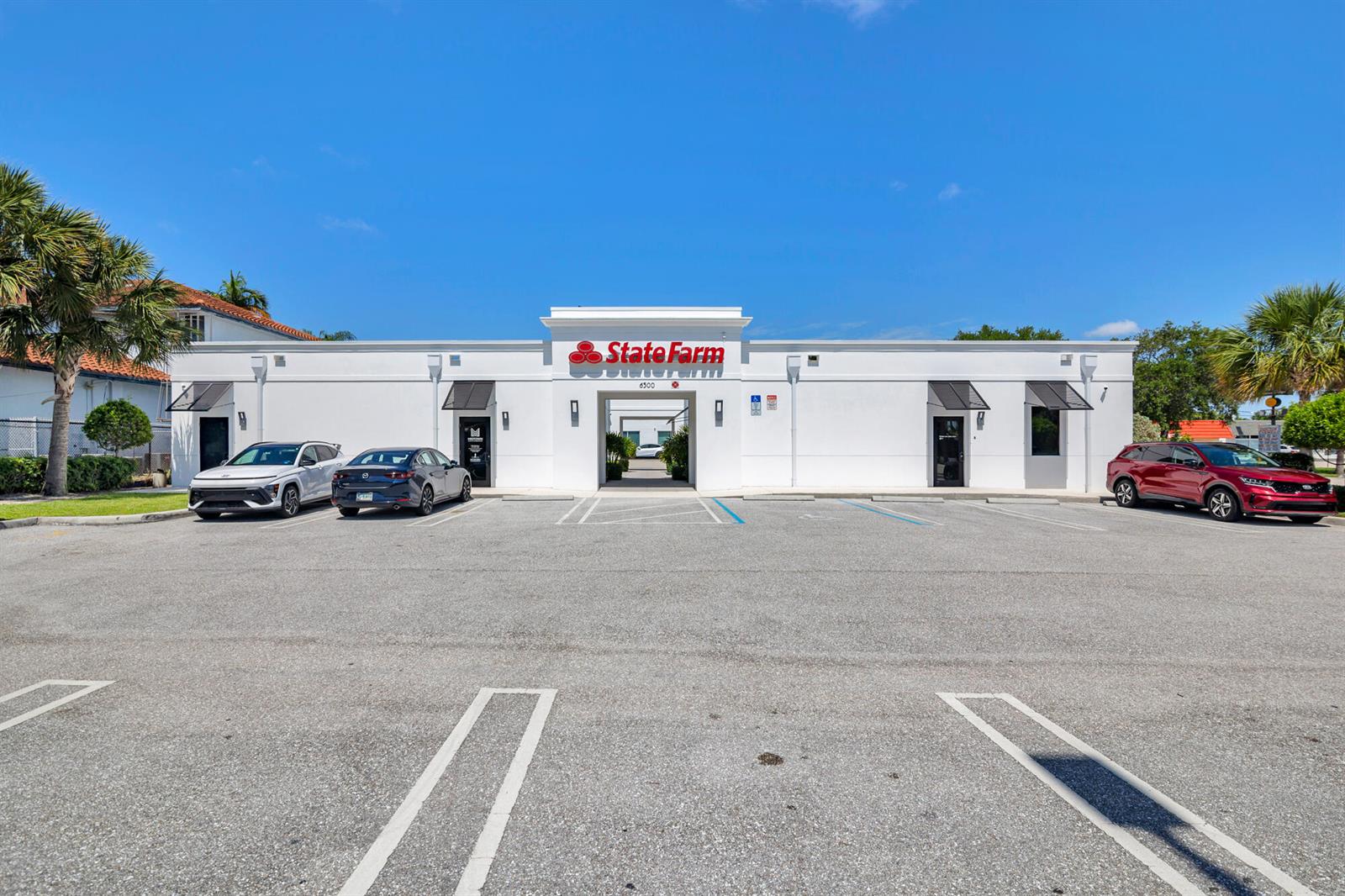 A white commercial building with a State Farm sign and parking lot under a blue sky — 6500 S Dixie Highway # C, West Palm Beach FL 33405, WEST PALM BEACH, FL
