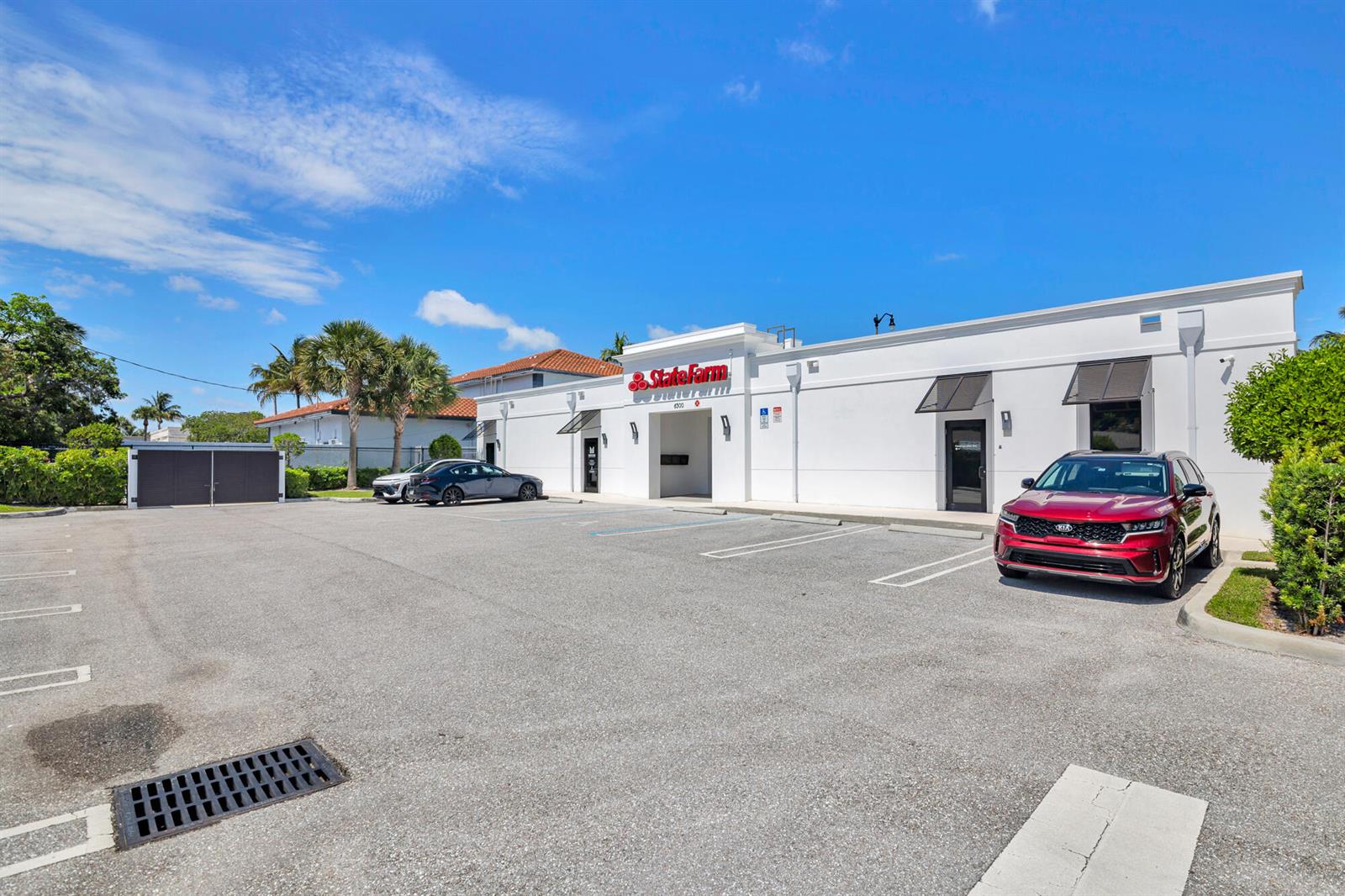 A white commercial building with a State Farm sign sits behind a paved parking lot — 6500 S Dixie Highway # C, West Palm Beach FL 33405, WEST PALM BEACH, FL