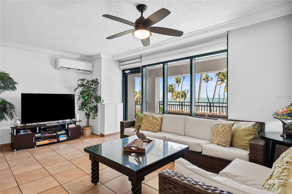 A living room features tile floors, a ceiling fan, a sofa, and a balcony view — 6100 RIO MAR UNIT 829899, RIO GRANDE, PR