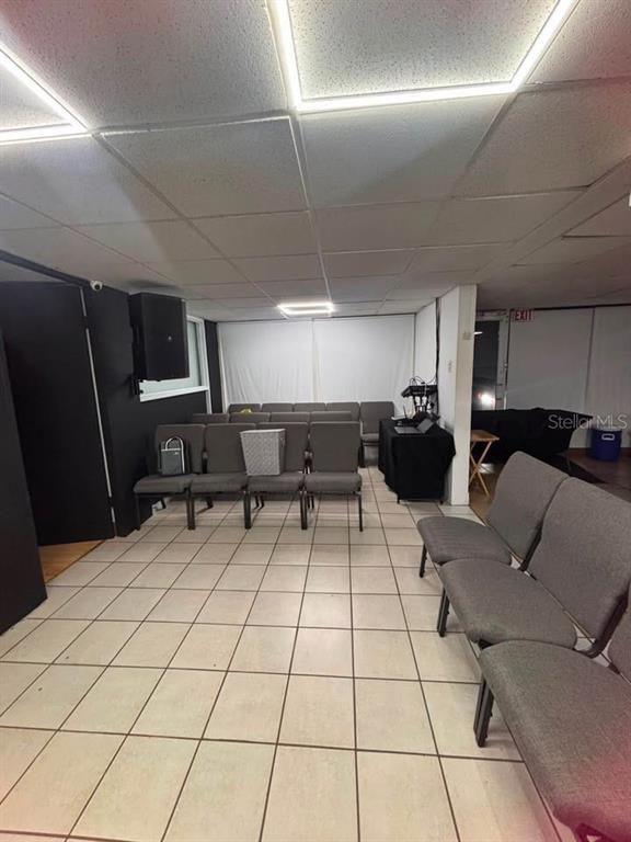 A room with a drop ceiling, tile floors, and rows of gray chairs — 22 URB. RIVERVIEW AA1, CALLE 22, BAYAMON, PR