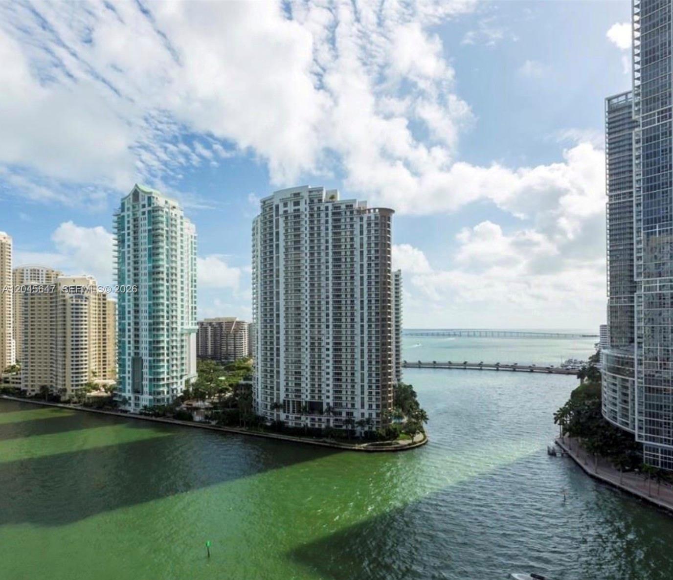 An exterior view of high-rise apartment buildings situated on a waterfront peninsula — 300 S Biscayne Blvd # 2302, Miami FL 33131, MIAMI, FL