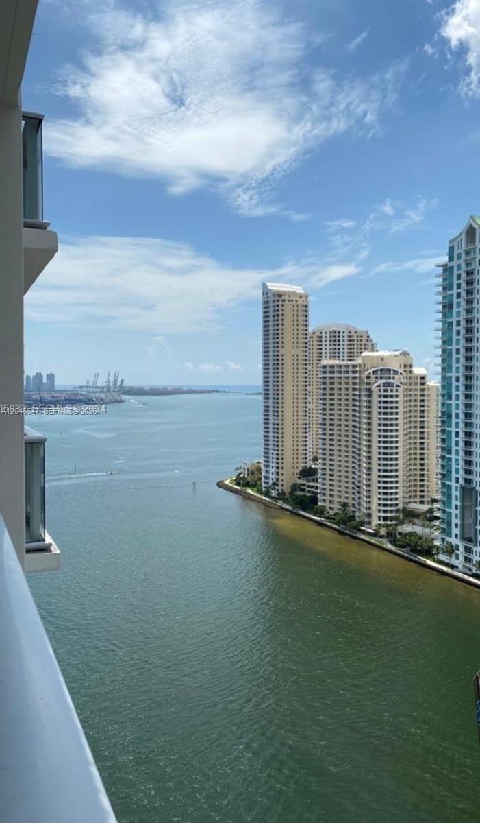 A high-angle view of a bay with several tall residential buildings along the shoreline — 300 S Biscayne Blvd # 2302, Miami FL 33131, MIAMI, FL