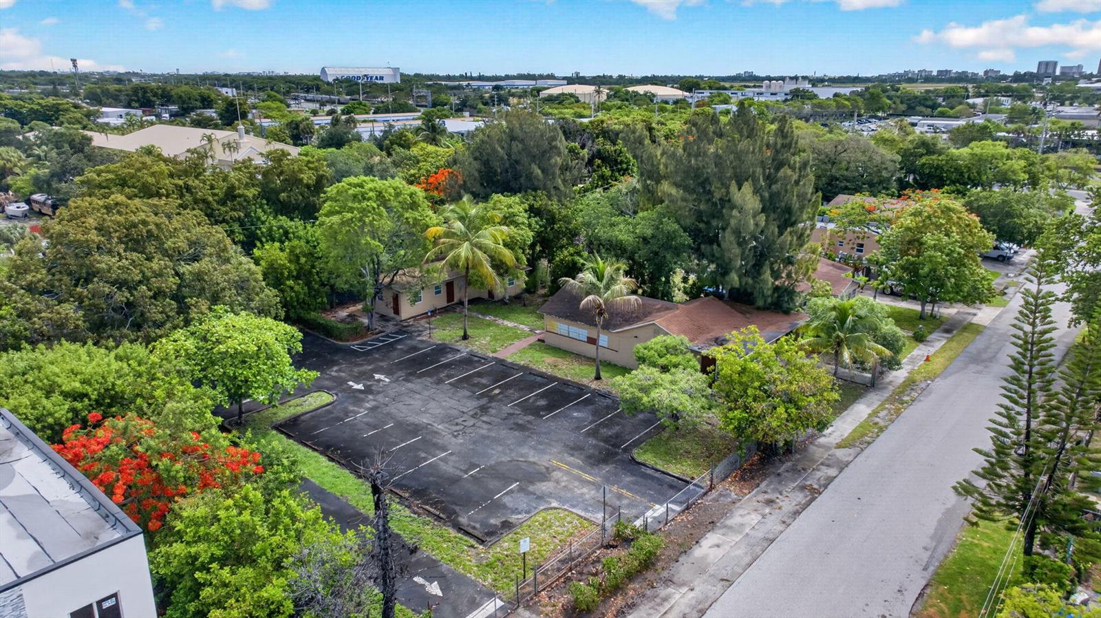 An aerial view shows a parking lot in front of a single-story building with trees — 129 NW 11th Street, Pompano Beach FL 33060, POMPANO BEACH, FL