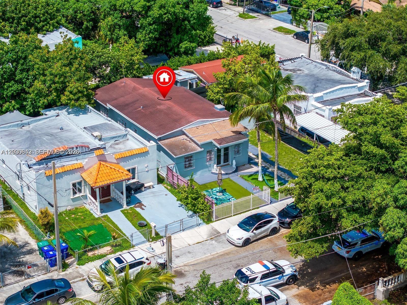 An aerial view shows two adjacent single-story houses with fenced yards and parked cars — 3128 NW 3rd Ave, Miami FL 33127, MIAMI, FL