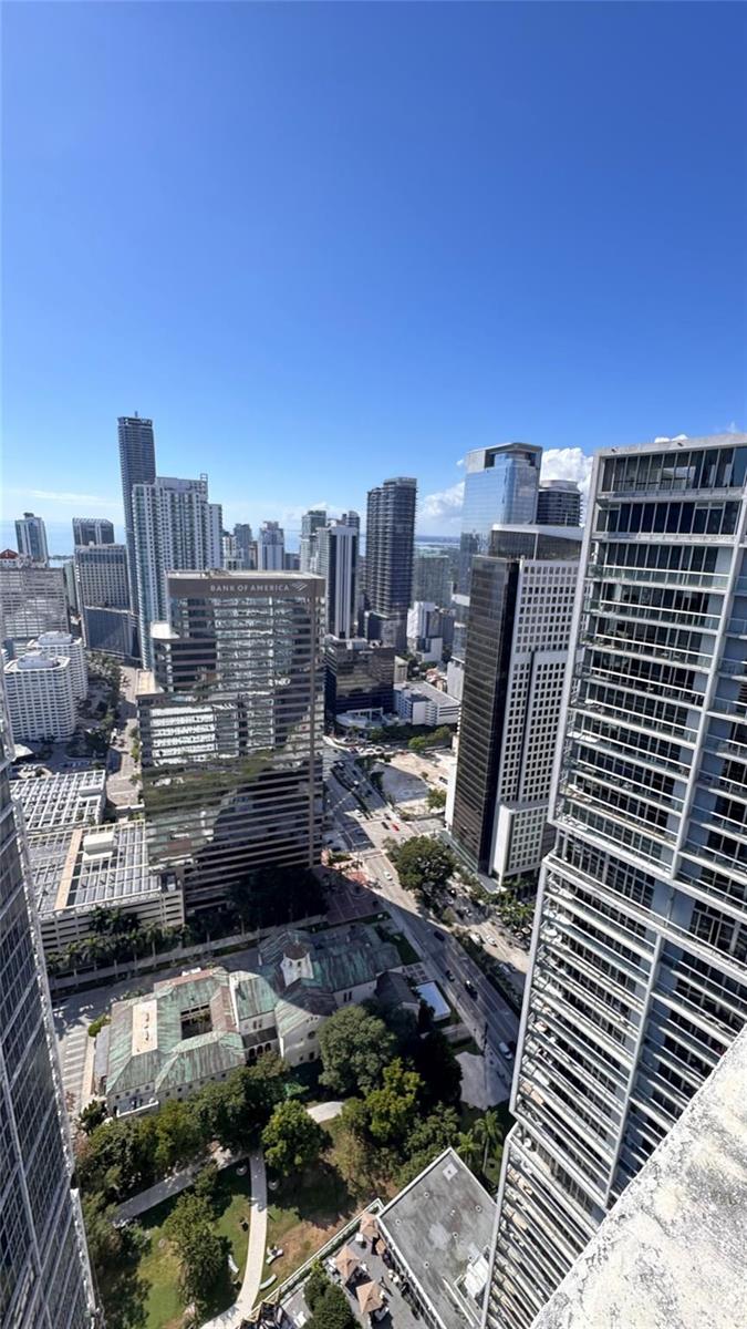 An elevated view of a dense urban skyline featuring numerous skyscrapers and a green park — 475 Brickell Avenue # 4913, Miami FL 33131, MIAMI, FL