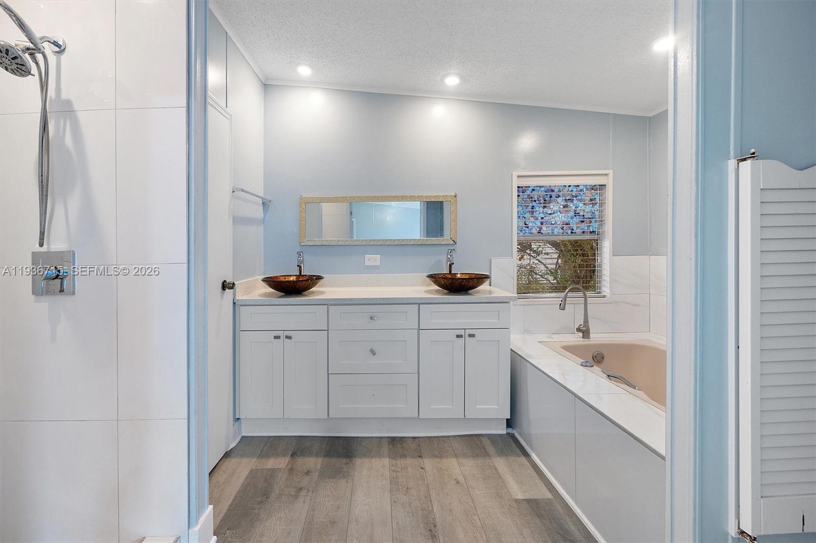A bathroom features a double vanity with vessel sinks, a soaking tub, and a shower — 19800 SW 180th Ave Lot 222, Miami FL 33187, MIAMI, FL