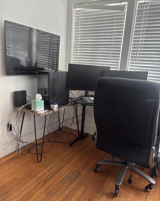 A home office features a computer desk with multiple monitors, a gaming chair, and hardwood floors — 2601 W CLEVELAND STREET, TAMPA, FL