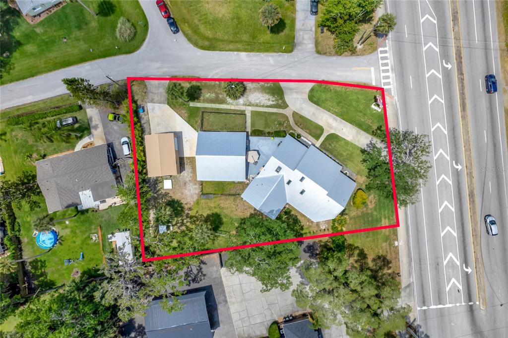 An aerial view shows a house with a metal roof and a detached garage — 335 DEBARY AVENUE, DEBARY, FL