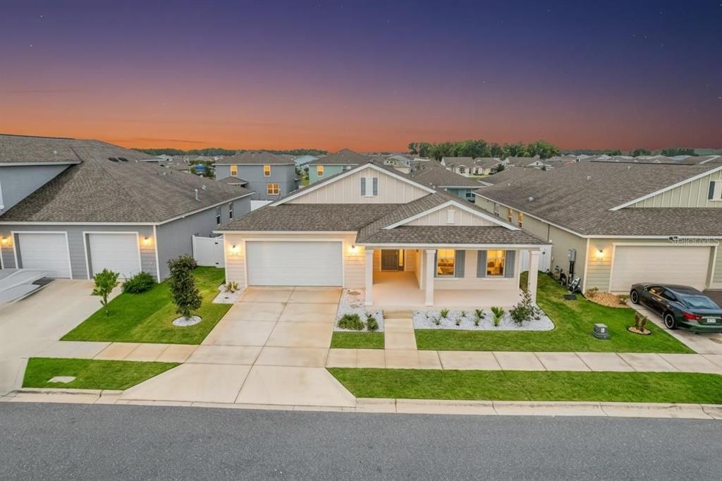 An exterior view of a single-story suburban house with a two-car garage and front porch — 6200 SW 72ND TERRACE, OCALA, FL