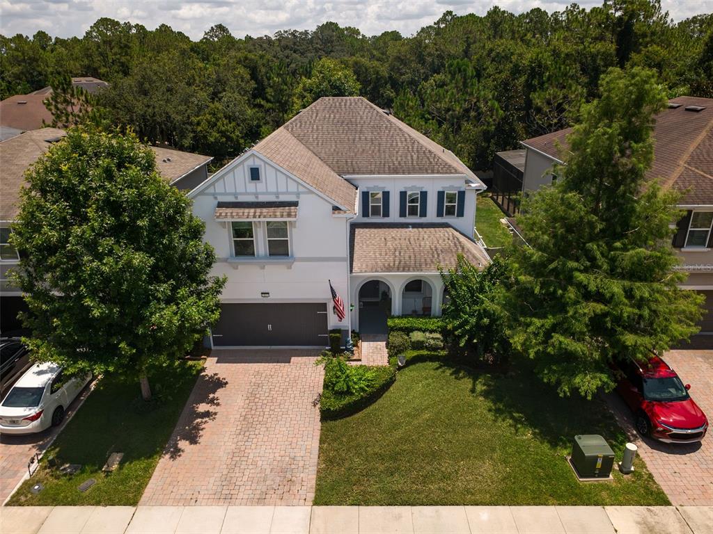 An aerial view of a two-story suburban house with a paved driveway and front lawn — 2317 AVELLINO AVENUE, ST CLOUD, FL