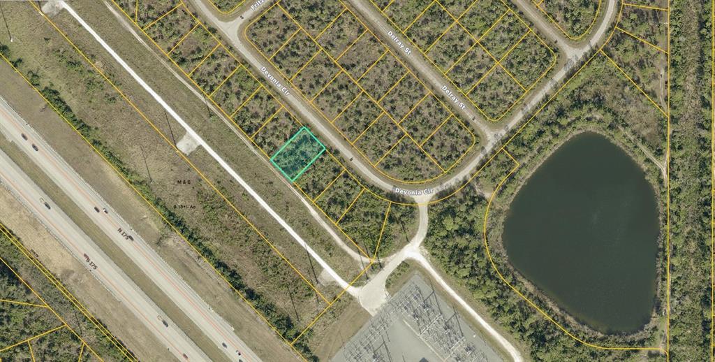 An aerial map shows a highlighted vacant lot located along a curved residential street — 1151219204 DEVONIA CIRCLE, NORTH PORT, FL