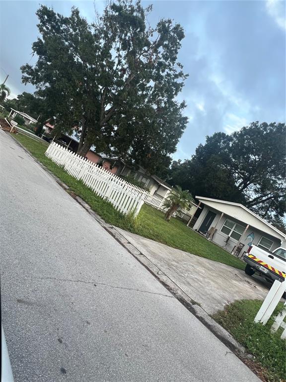 A white house with a white picket fence and a truck parked in the driveway — 3945 47TH STREET, VERO BEACH, FL