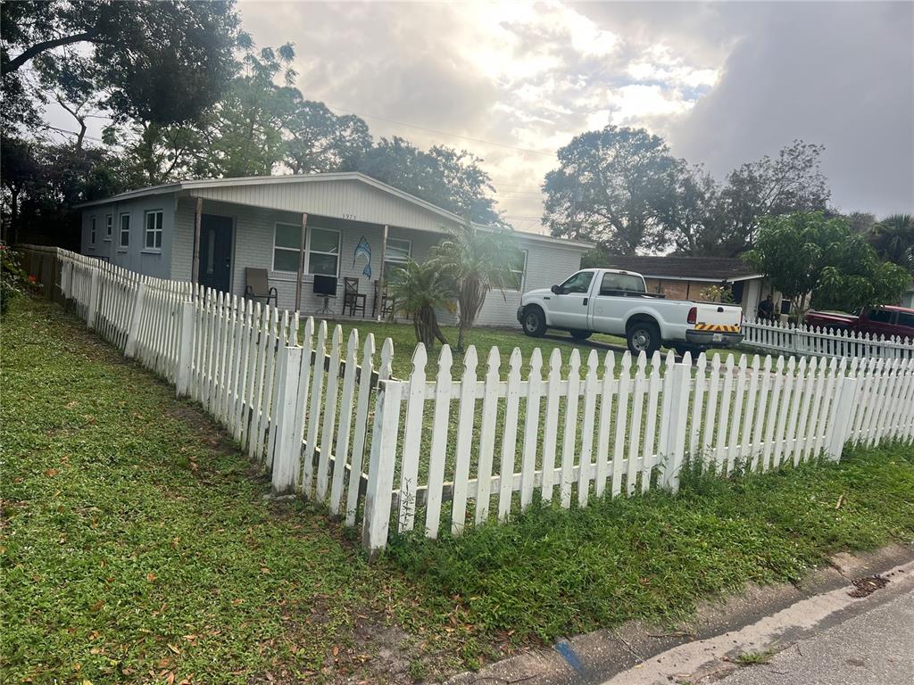 A single-story house with a white picket fence and a white pickup truck parked outside — 3945 47TH STREET, VERO BEACH, FL