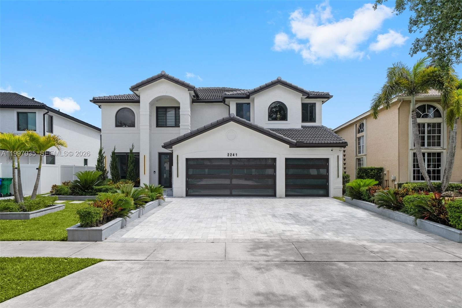 A two-story white house with a three-car garage and a paved driveway — 2241 SW 164th Ave, Miramar FL 33027, MIRAMAR, FL