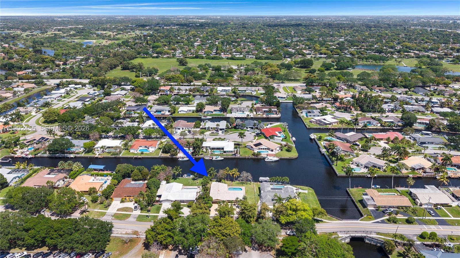 An aerial view shows a residential neighborhood with houses, swimming pools, and a canal — 6121 SW 16th St, Plantation FL 33317, PLANTATION, FL