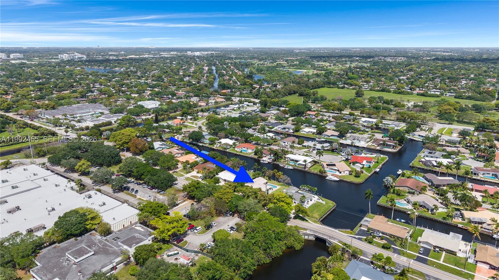 An aerial view shows a residential house with a pool situated along a canal — 6121 SW 16th St, Plantation FL 33317, PLANTATION, FL