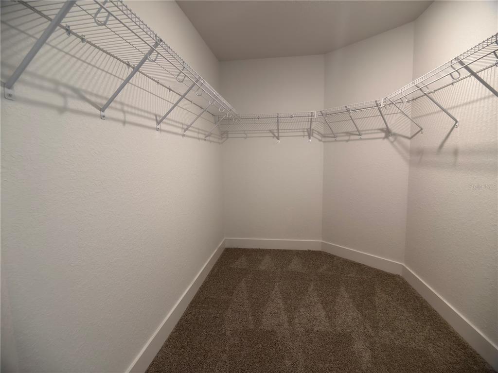A bathroom features a white soaking tub next to a glass-enclosed walk-in shower — 3147 NE 45TH AVENUE, OCALA, FL
