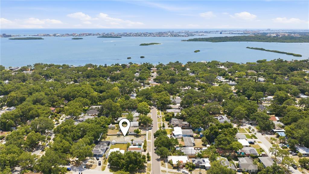 An aerial view shows a residential neighborhood with a vacant lot marked by a pin — 8056 28TH AVENUE N, ST PETERSBURG, FL