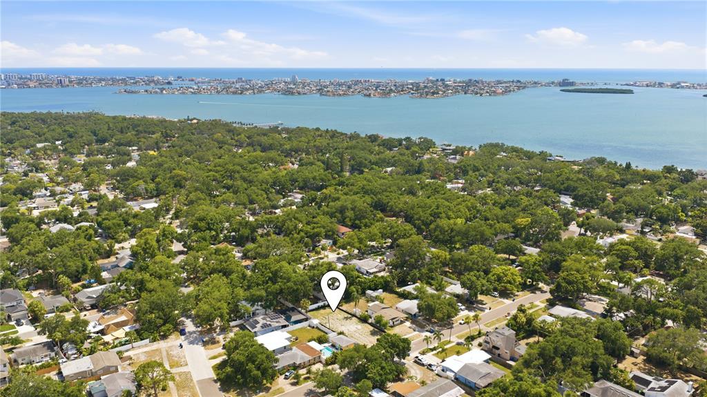 An aerial view shows a vacant residential lot marked by a pin in a neighborhood — 8056 28TH AVENUE N, ST PETERSBURG, FL
