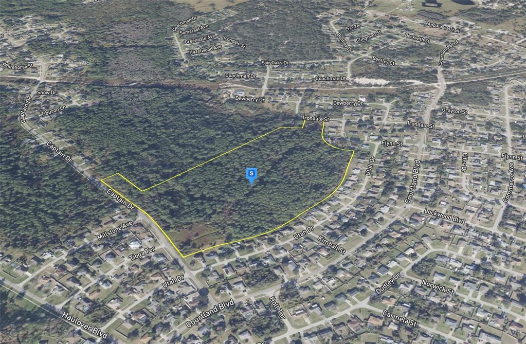 An aerial map view shows a large, undeveloped wooded lot outlined in yellow — 2700 CAPTAIN DRIVE, DELTONA, FL