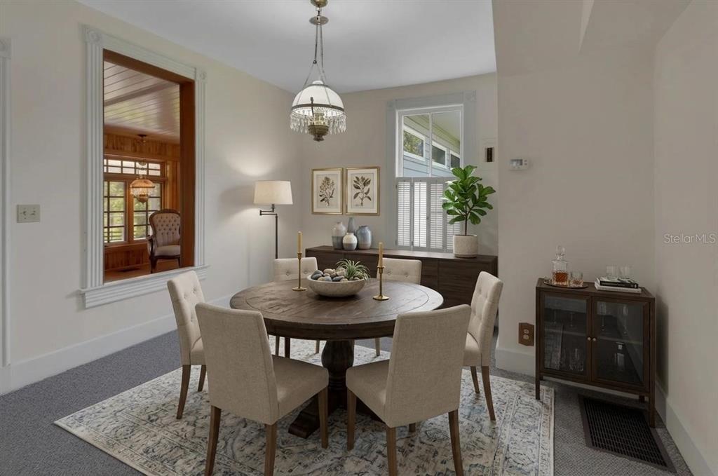 A dining room features a round wooden table, four upholstered chairs, and a crystal chandelier — 900 E KICKLIGHTER (5 +- ACRES) ROAD, LAKE HELEN, FL