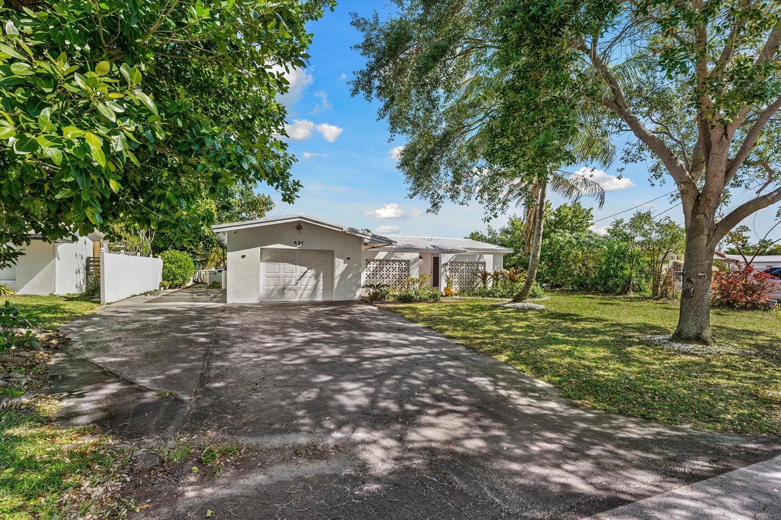 A single-story house with a white exterior, a one-car garage, and a large front yard — 421 SW 18th Street, Pompano Beach FL 33060, POMPANO BEACH, FL