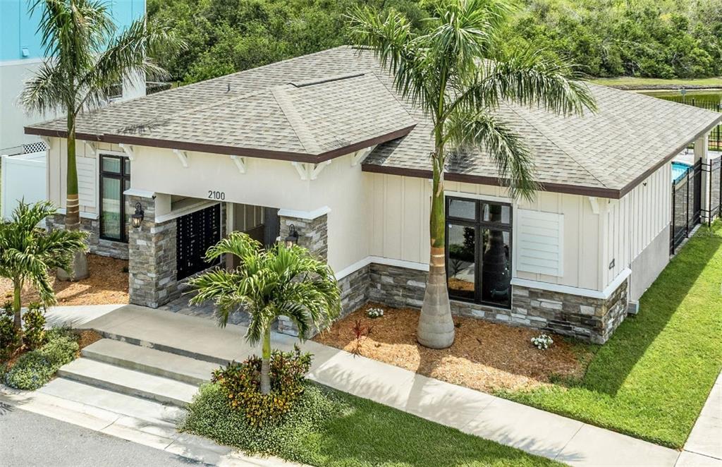 A single-story building with a stone facade, palm trees, and a shingled roof — 3301 WHITNEY ROAD UNIT 2102, 2104, 2106, Et al., CLEARWATER, FL