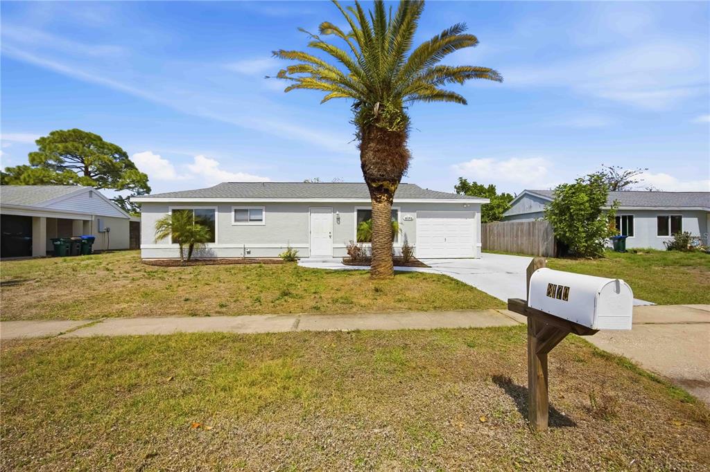 A single-story house with a palm tree in the front yard and a white mailbox — 8170 LOMBRA AVENUE, NORTH PORT, FL