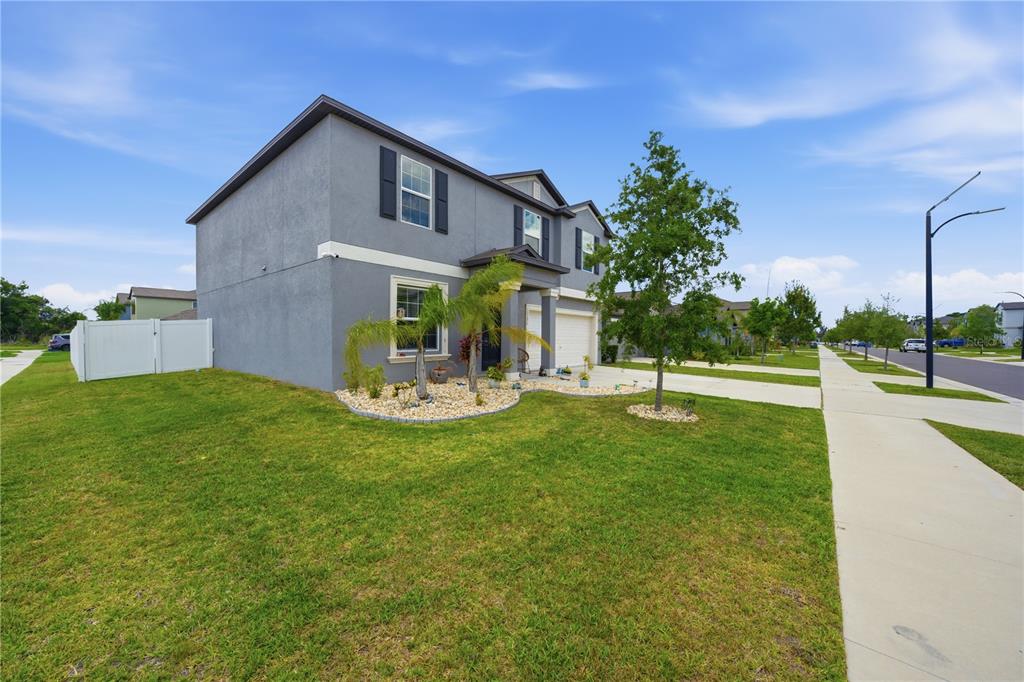 A two-story gray house with a white garage and a landscaped front yard — 10291 SHADY PRESERVE DRIVE, RIVERVIEW, FL