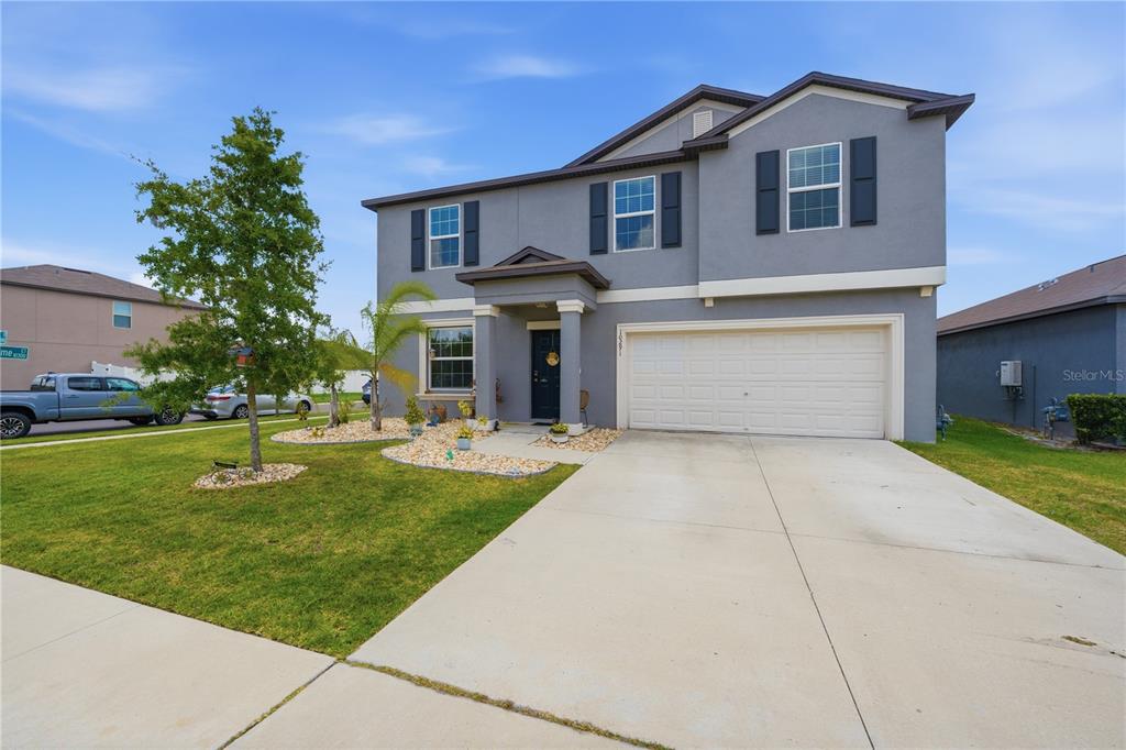 A two-story gray house with a two-car garage and a front lawn — 10291 SHADY PRESERVE DRIVE, RIVERVIEW, FL