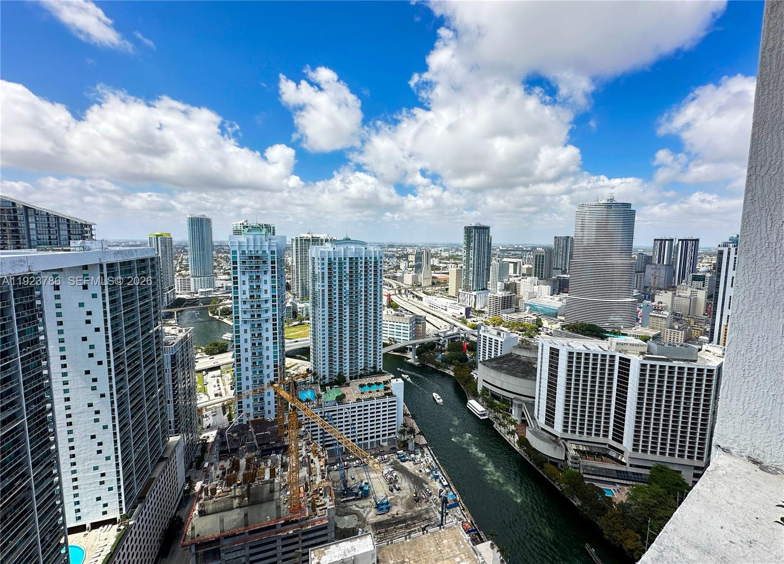 An elevated view of a city skyline featuring skyscrapers, a river, and a construction site — 485 Brickell Ave # 4405, Miami FL 33131, MIAMI, FL
