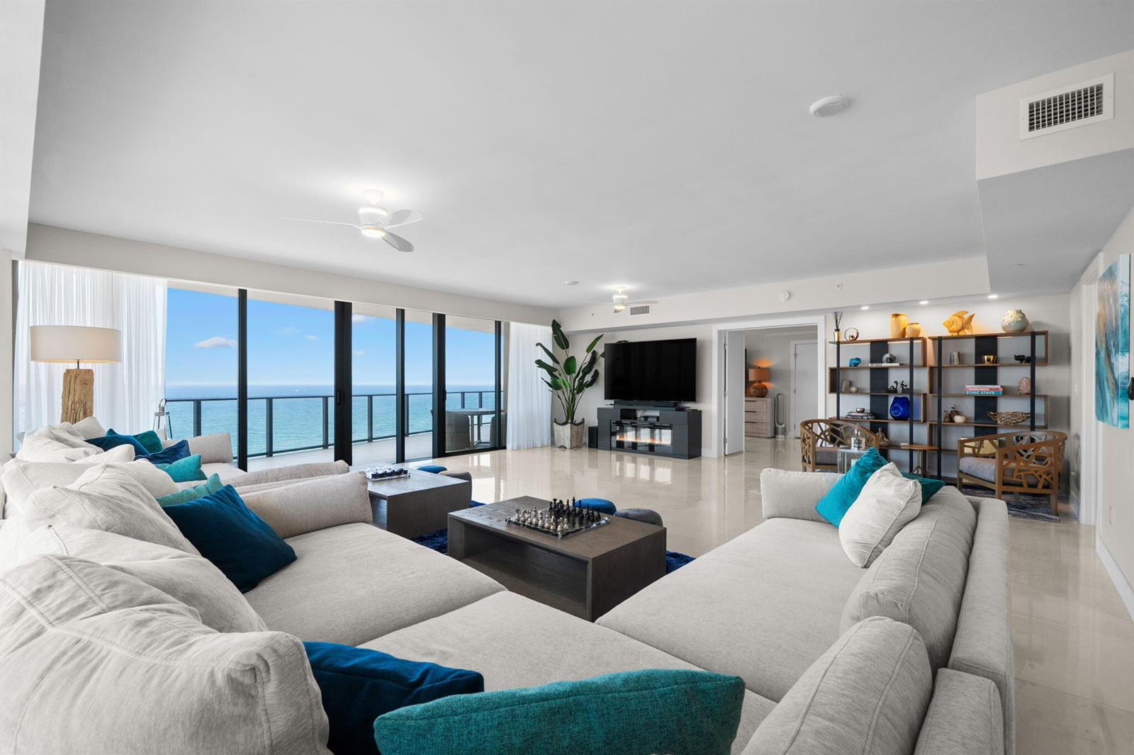 A spacious living room features light tile floors, a large sectional sofa, and ocean views — 730 N Ocean Boulevard # 1703, Pompano Beach FL 33062, POMPANO BEACH, FL