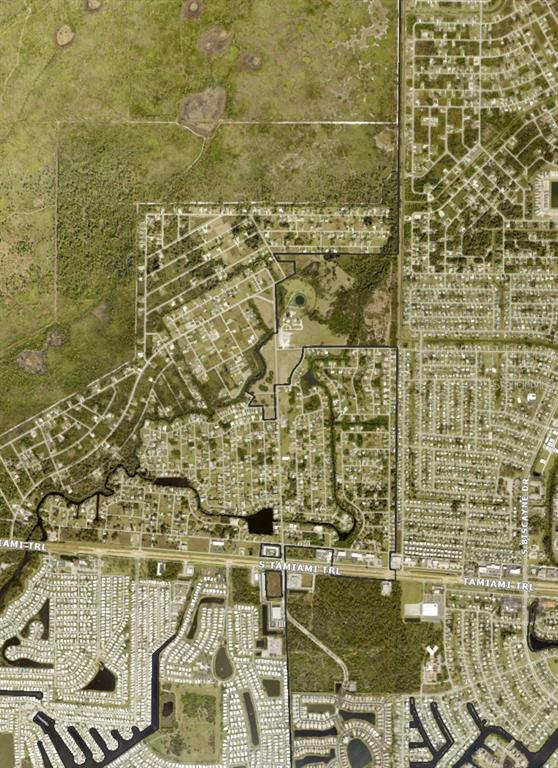 This is an aerial map showing a residential area bordered by a highway and wetlands — SAN REMO STREET, NORTH PORT, FL