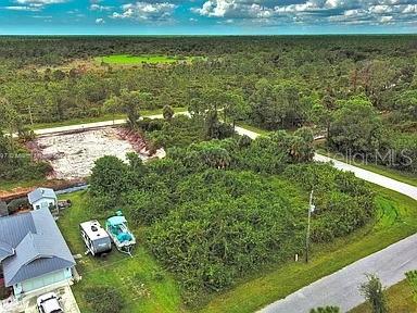 An aerial view shows a vacant, wooded lot next to a house with a camper — 4137 CHIPPEWA STREET, PORT CHARLOTTE, FL